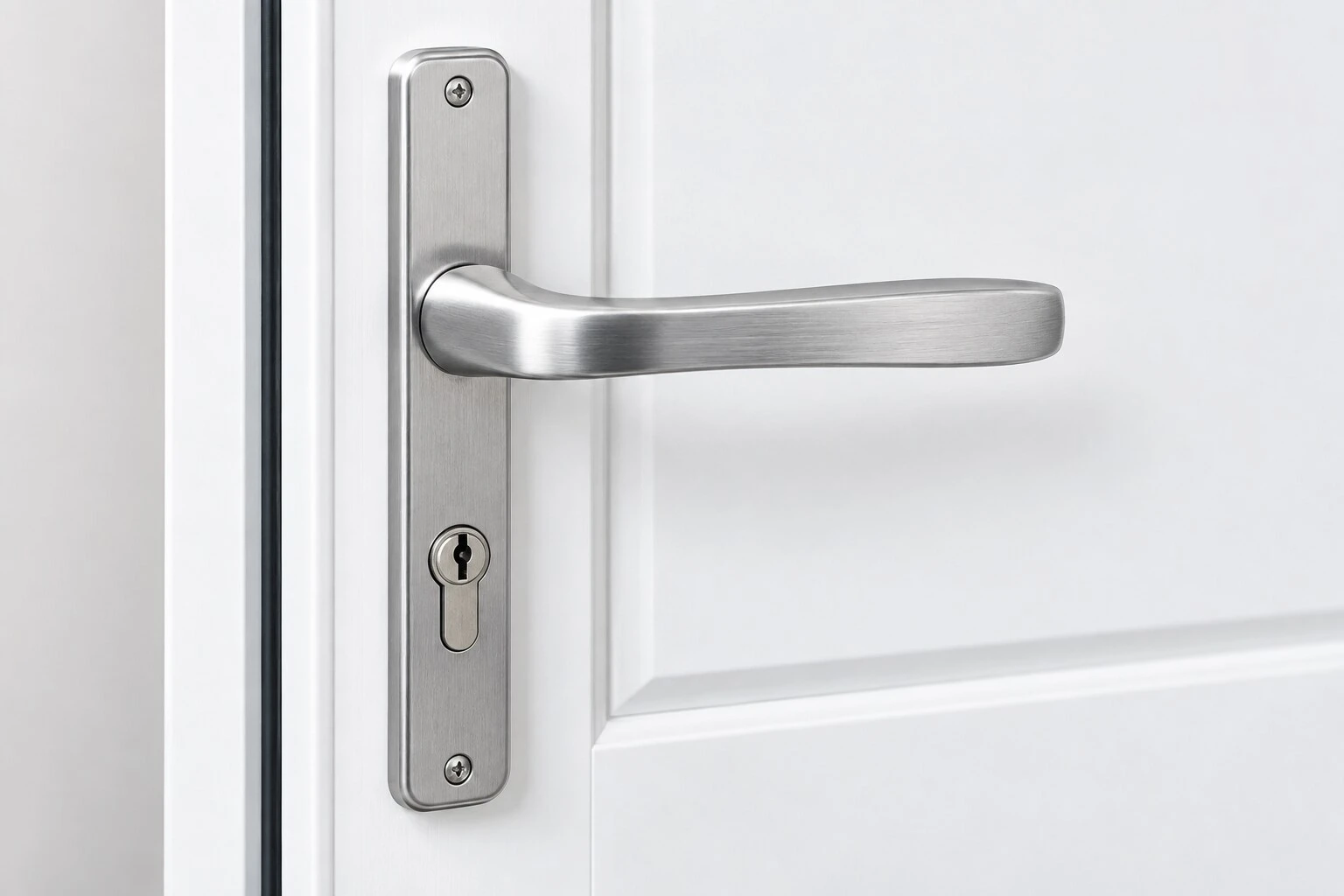 Brushed chrome uPVC door handle fitted to a white door
